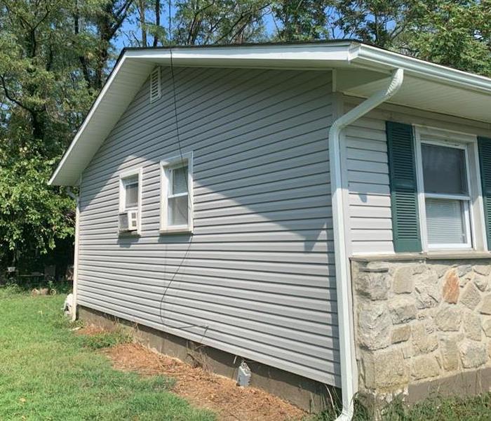 Side of house showing after new siding and roof