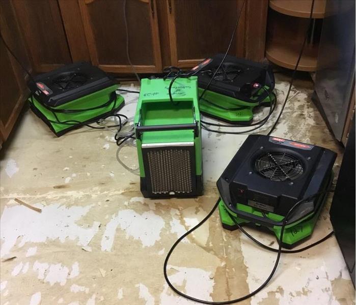 kitchen floor after vinyl removed with air movers and dehumidifier